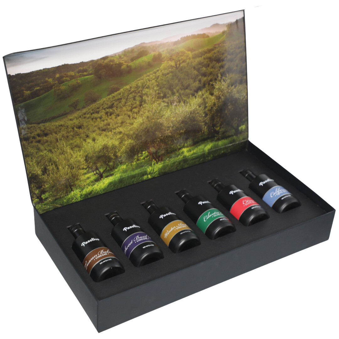 Premium Pasolivo products packaged in beautiful black box with green olive orchard imagery.