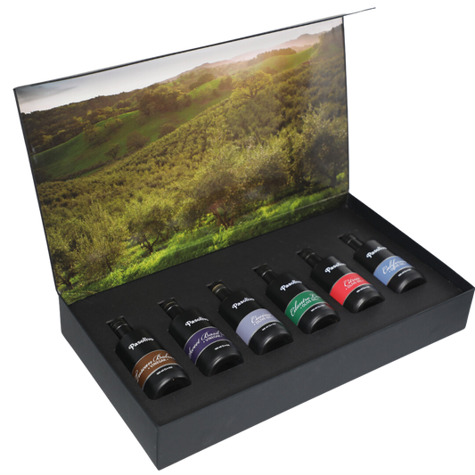 Premium Pasolivo products packaged in beautiful black box with green olive orchard imagery.