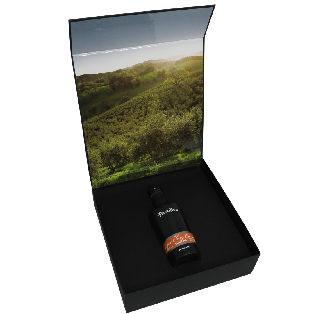 Premium Pasolivo products packaged in beautiful black box with green olive orchard imagery.