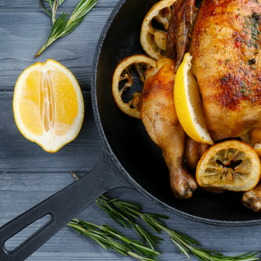 Pasolivo Italian Chicken Recipe garnished with lemon wedges and rosemary