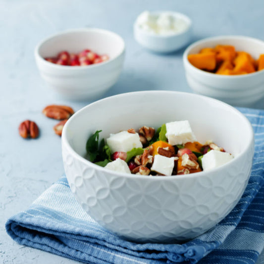 Pasolivo Roasted Pumpkin with Walnuts and Feta Recipe on a table with a towel and ingredients