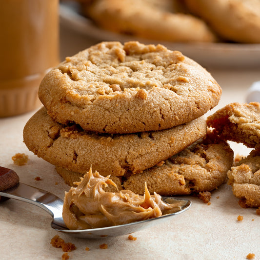 Pasolivo Peanut Butter Cookie Recipe next to spoonful of peanut butter