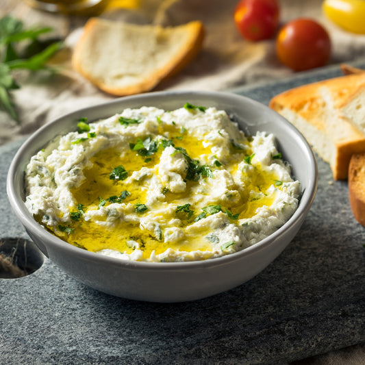 Pasolivo Basil Feta Dip Recipe next to bread and tomatoes