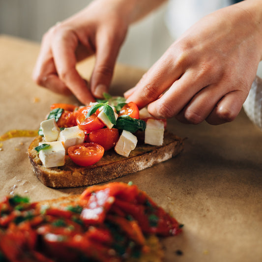 Pasolivo Bruschetta Flight Recipe being garnished with herbs