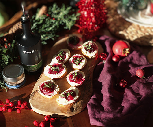 Pasolivo Cranberry Basil Crostini Recipe on tablecloth next to Pasolivo Oils and Spices