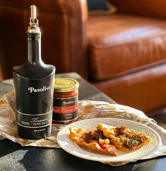 Pasolivo Fennel & Sausage Pizza Recipe plated on a table next to Sweet Tomato Fennel Spread and Tuscan Olive Oil