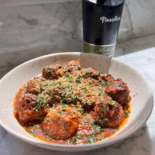 Pasolivo Lamb Meatballs Recipe on a countertop next to Pasolivo Il Singolo Olive Oil