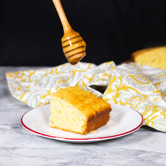 Pasolivo Lime Cornbread Recipe being drizzled with honey