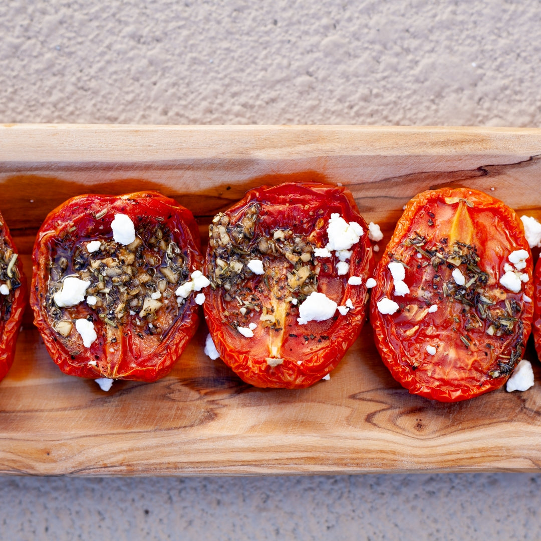 Oven Dried Tomatoes Recipe plated on wooden cutting board