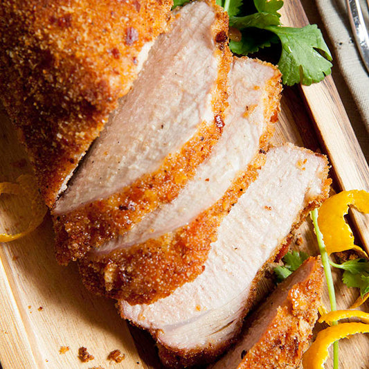 Pasolivo Pork Tenderloin Recipe garnished with tangerine peels and herbs